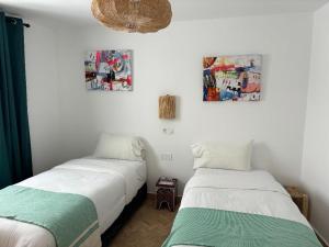 two beds sitting next to each other in a room at RIAD OASIS D'ASILAH in Asilah