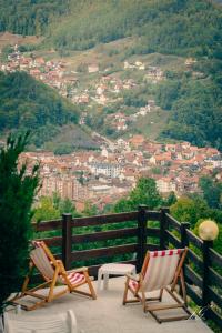 two chairs on a balcony with a view of a city at "Naše Brdo" - Ivanjica in Ivanjica