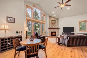 a living room with a couch and a table at BEST VIEWS! Luxury Mountain Home - Saltwater HotTub, Firepit, BBQ- Close to Trails, Red Rocks in Evergreen