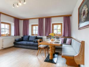 a living room with a table and a couch at Bauernhof Seppen in Reith im Alpbachtal