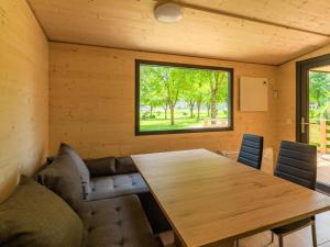 a dining room with a wooden table and chairs at Wood Cube an der Drau in Sachsenburg