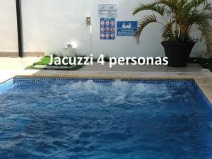 a blue swimming pool with the words jago pegasos at Private pool villa with jacuzzi, near beaches in Punta Cana
