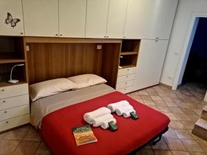 a bedroom with a bed with two towels on it at Casa Soprani - Relax Marchigiano in Castelfidardo