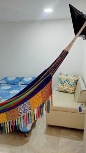 a hammock in a room with a bed and a couch at Hotel Luxury Plaza in San Jacinto