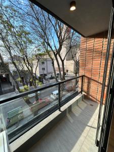 a balcony with a view of a street from a house at Edificio M1 - Apartamentos frente a Punta Carretas Shopping - Gym Laundry Parrillero Solarium in Montevideo