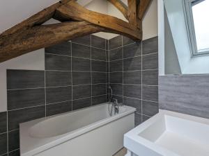 La salle de bains est pourvue d'une baignoire blanche et d'une fenêtre. dans l'établissement Grande Maison de Campagne avec Jardin Clos, Proche Levroux, 12 Pers., Châteaux, Zoo de Beauval - FR-1-591-176, à Levroux 24 autres photos