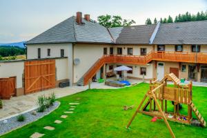 ein Haus mit einem Spielplatz davor in der Unterkunft Wittinghof in Julbach