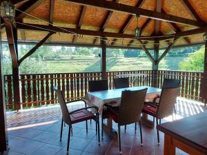 a porch with a table and chairs on a deck at Holiday house with a parking space Generalski Stol, Karlovac - 22148 in Generalski Stol
