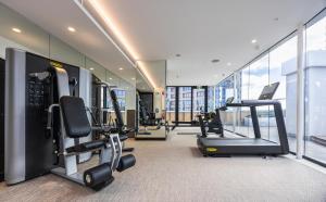 - une salle de sport avec tapis de course et vélos elliptiques dans un bâtiment dans l'établissement Accommodation Sydney City Centre 1 Bedroom Apartment with Balcony, à Sydney