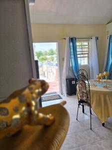 a toy bear sitting on a table in a living room at Bornu Apartment in Bridgetown