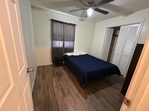 a bedroom with a bed and a ceiling fan at 14% Discount for 1 Week 22% Discount for 1 Month in Lawton