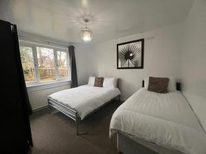 a bedroom with two beds and a window at Shared House in central location Inverness in Inverness