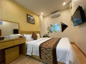 Habitación de hotel con cama grande y espejo en Mely Hotel Hà Nội, en Hanói