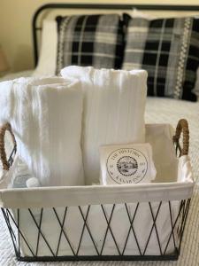 a basket with towels in it on a bed at The Founders Suite at The Historic Kanab Inn in Kanab