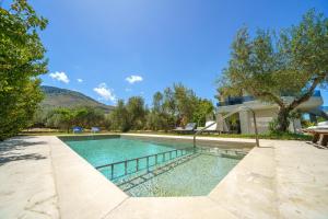 a swimming pool in the backyard of a house at Luxury Villa Marian with Private Pool and Jacuzzi near the Beach of Georgioupoli in Georgioupolis +42 photos