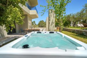 a hot tub in the backyard of a house at Villa Marian with Private Swimming Pool & Jacuzzi in Georgioupolis