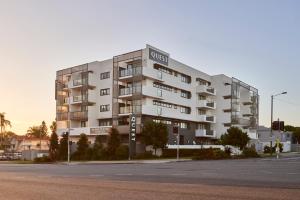 een wit gebouw met een bord aan de zijkant bij Quest Cannon Hill in Brisbane