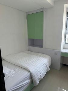 a white room with a bed with a mirror at 温馨小屋18 in Bandung