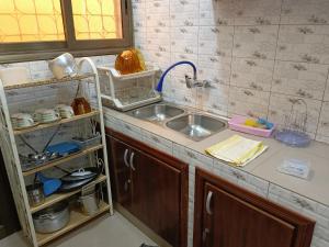 a kitchen with a sink and a counter top at Résidence Lynda Prestige in Ouagadougou