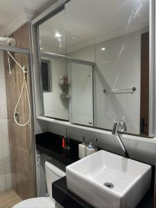 a bathroom with a white sink and a mirror at Apartamento centro de Paulista-Pe in Paulista