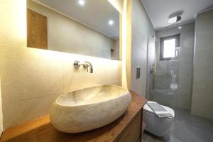 a bathroom with a large stone sink on a counter at Villa Marian with Private Swimming Pool & Jacuzzi in Georgioupolis