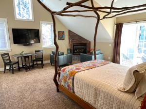 1 dormitorio con 1 cama y chimenea en Goldberry Woods- A Modern Farm Resort, en Union Pier