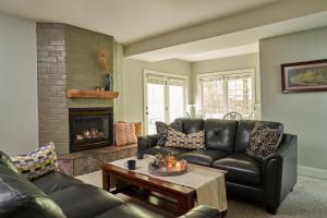 a living room with a couch and a fireplace at Goldberry Woods- A Modern Farm Resort in Union Pier
