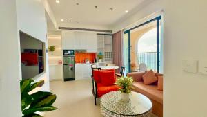 a living room with a couch and a table at Harry Phu Quoc Hotel in Phú Quốc