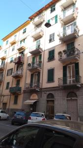 a tall building with cars parked in front of it at Casa marzia in La Spezia