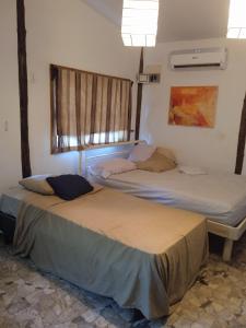 Łóżko lub łóżka w pokoju w obiekcie casa de huéspedes selvatica