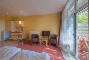 a bedroom with a bed and a table and chairs at Strandläufer 111 in Granzow
