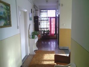 a hallway of a house with a couch and a window at Centrum Panzió in Kaposvár