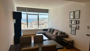 a living room with a couch and a table and a window at hilton apartement families in Tangier