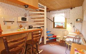 a small room with a kitchen and a spiral staircase at Cozy Home In Waren mritz With Kitchen in Kölpinsee
