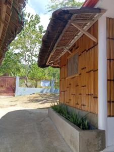 a building with a wooden wall with a window at Rose Apartments in Anda +36 photos