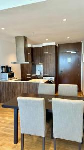 a kitchen with a table and some chairs and a counter at hilton apartement families in Tangier