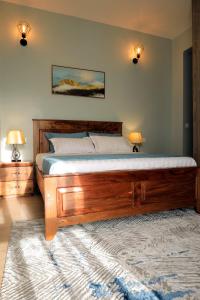 a bedroom with a bed with a wooden frame at Bella Vista in Wakiso