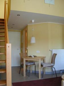 a dining room with a table and chairs at Schneeeule 225 in Granzow +10 photos