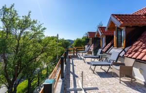 a row of chairs on a balcony of a building at 2 Bedroom Beautiful Home In Gornji Lopci in Sveti Mihovil