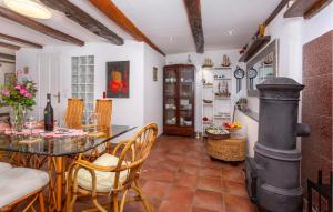 a kitchen with a table and a wood stove at 2 Bedroom Beautiful Home In Gornji Lopci in Sveti Mihovil