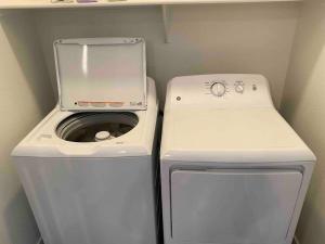a washing machine and a washer in a small room at Gateway to Old Town Scottsdale King 1 BR & Balcony in Scottsdale