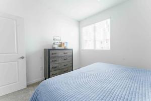 a bedroom with a bed and a dresser and a window at Gateway to Old Town Scottsdale King 1 BR & Balcony in Scottsdale