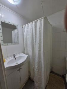a bathroom with a sink and a shower curtain at Hosteria Piedra Blanca in Taltal +25 photos