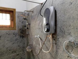 a phone on a wall in a bathroom at Villa 39 Katunayake Airport transit villa in Katunayake