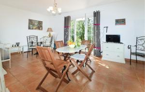 a dining room and living room with a table and chairs at Cozy Home In Piscia Rossa With House A Panoramic View in Afa
