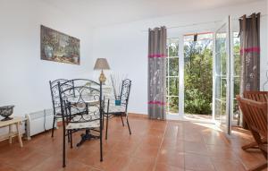 a living room with a table and chairs and windows at Cozy Home In Piscia Rossa With House A Panoramic View in Afa
