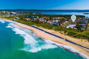 an aerial view of a beach with a hot air balloon at 6 Bedroom Beach & Lake Oasis in The Entrance