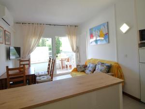 ein Wohnzimmer mit Sofa und Tisch in der Unterkunft Apartamento acogedor con piscina, WiFi y garaje cerca de la playa de La Farella, Llançà - ES-228-8 in Llança