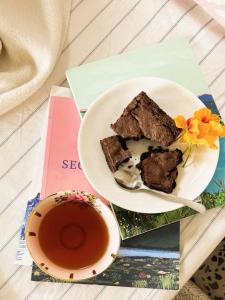 a plate of chocolate cake and a cup of tea at The Sugarbush in Cape Town