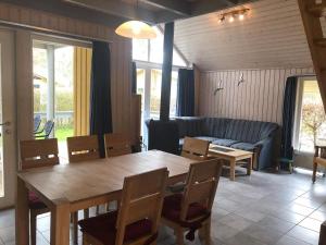 a living room with a wooden table and a couch at Seeschwalbe Classic 226 in Mirow